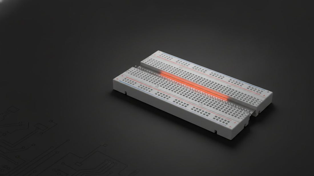 Breadboard cutaway showing metal contact strips beneath the holes